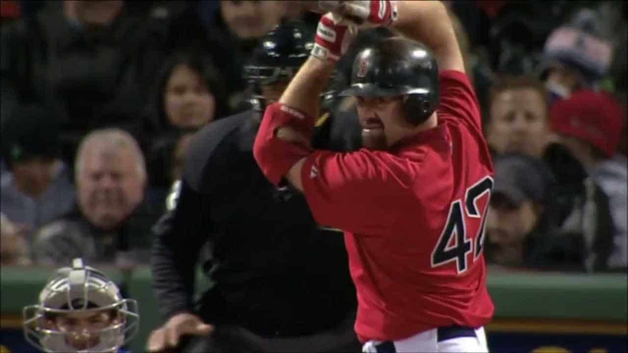 The 25 Men Who Made Fenway Sacred 3 Kevin Youkilis in action, showcasing his skills as a top first baseman of the 2000s.