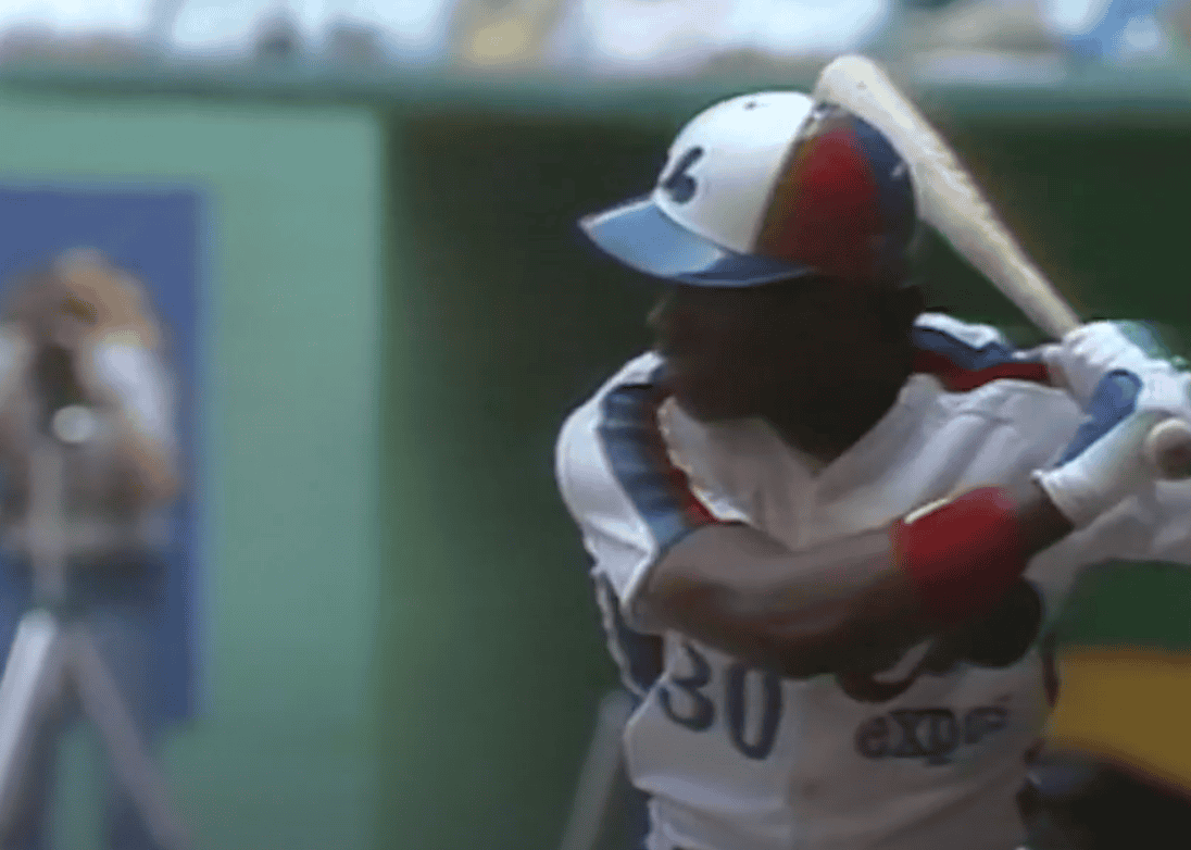 Tim Raines stealing a base, showcasing his speed and talent in baseball.