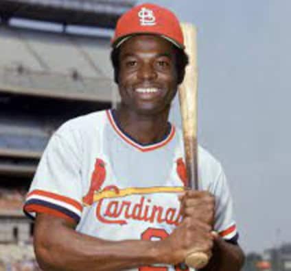Lou Brock in action, showcasing his speed and skill as a Cardinals player.