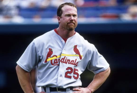 Mark McGwire celebrating a home run during the iconic chase that defined the steroid era.