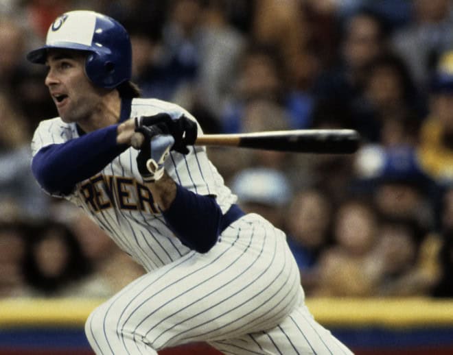 Paul Molitor, a dynamic third baseman, swings his bat with intensity during a game, showcasing his prowess on the field.
