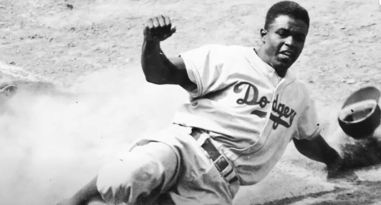 Jackie Robinson in action, symbolizing his impact on baseball and civil rights.