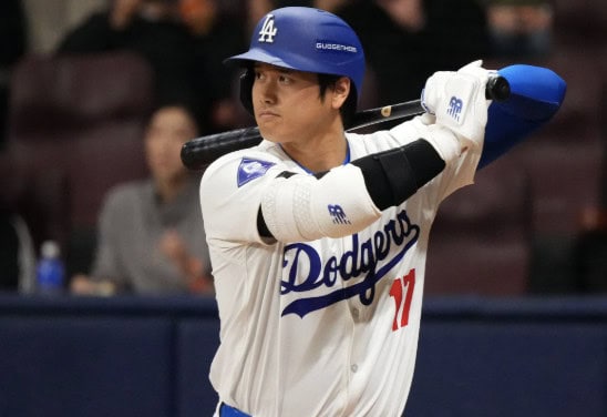 A dynamic image of Shohei Ohtani, showcasing his prowess as a two-way player for the Dodgers, highlighting his batting and pitching skills.