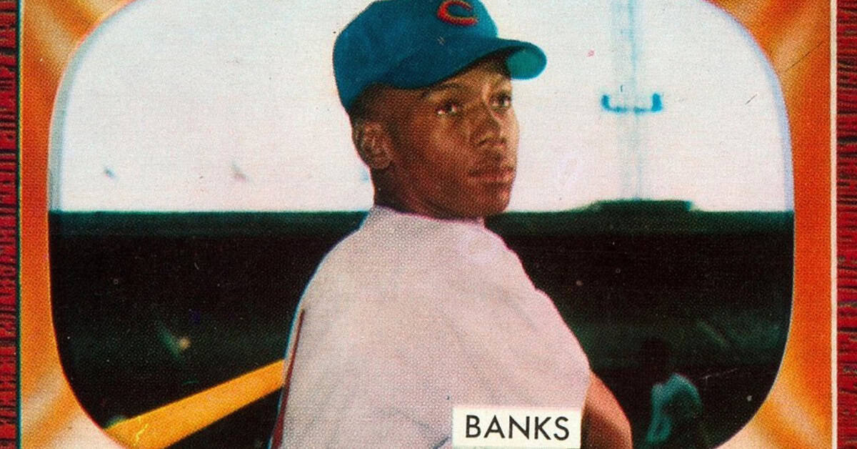Ernie Banks smiling on the field, embodying joy and excellence in baseball history.