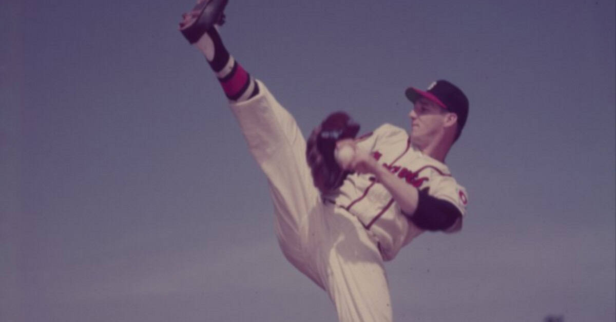 Seven Dates That Cracked Baseball Open Forever 11 Warren Spahn delivering a pitch, representing his legendary status in baseball history.