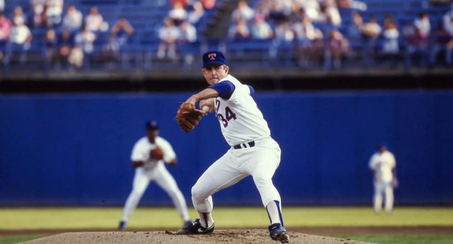 Nolan Ryan pitching, showcasing his dominance with 5,714 career strikeouts.