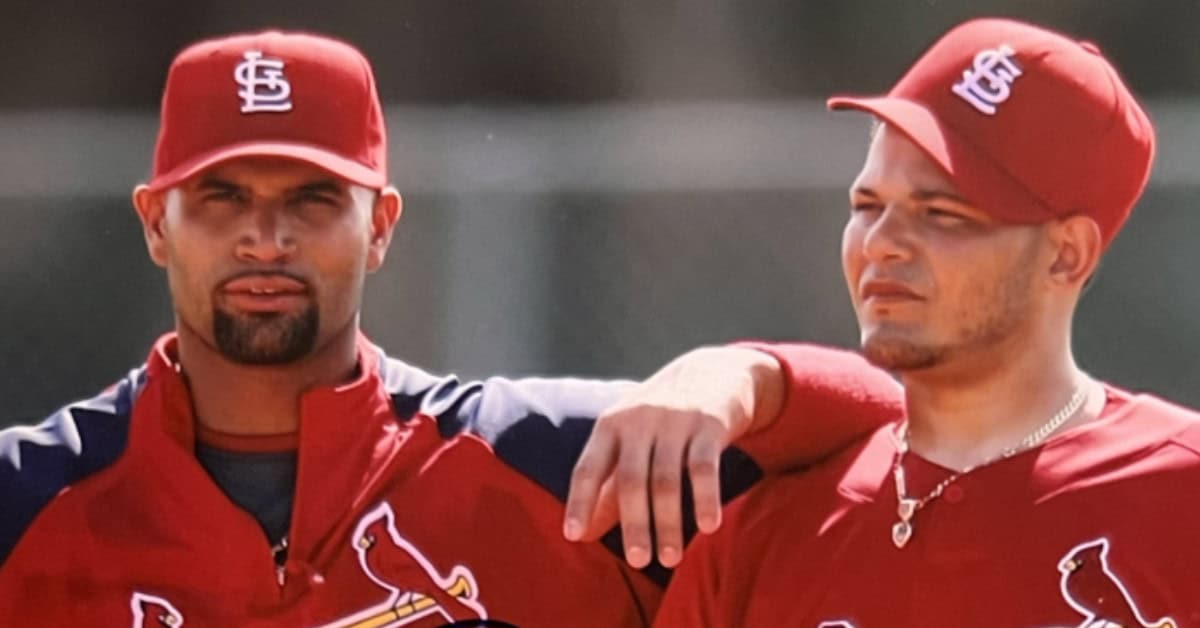 Albert Pujols and Yadier Molina celebrating a championship moment in MLB history.