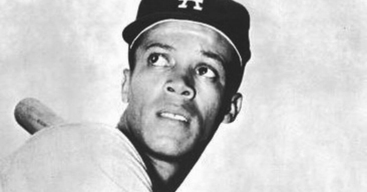 Maury Wills stealing a base, showcasing his speed record in baseball.