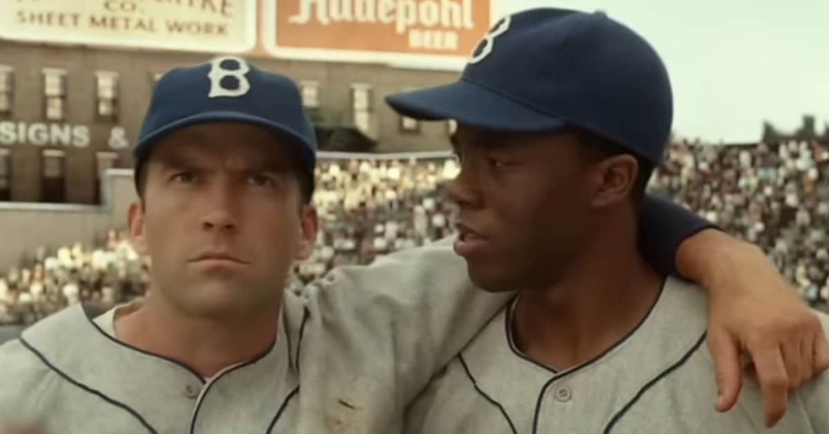 Pee Wee Reese and Jackie Robinson in "42," showcasing their historic moment in baseball.