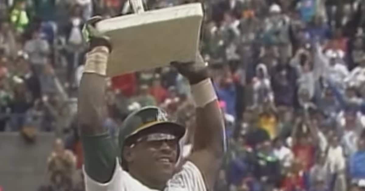 Rickey Henderson stealing a base, showcasing his legendary speed and skill.