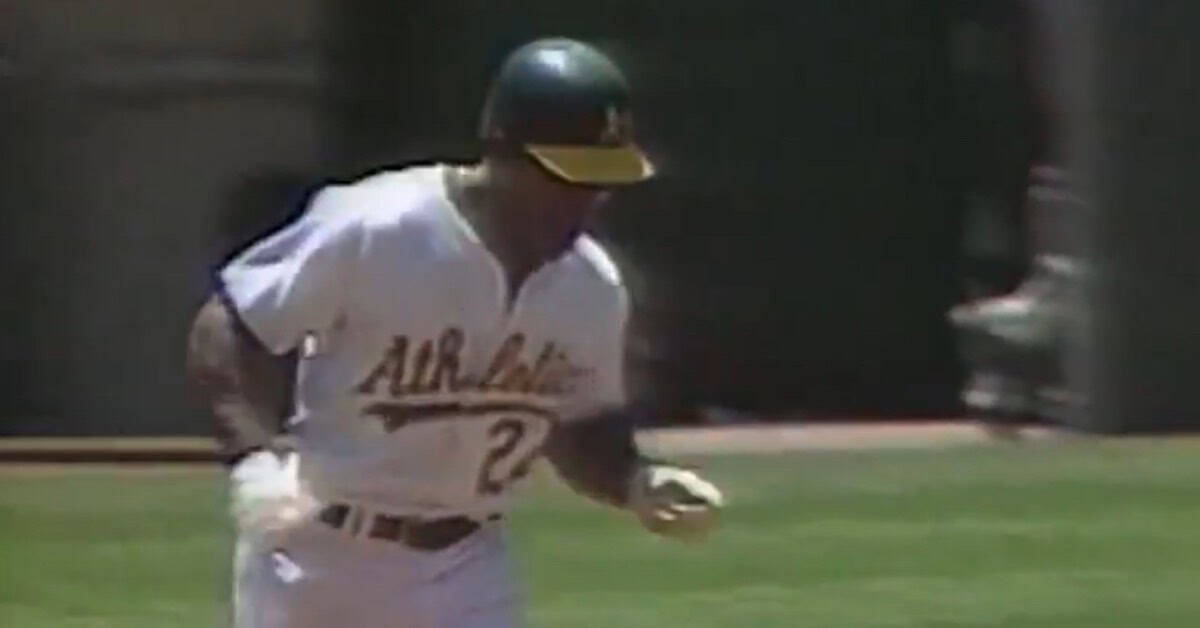 Rickey Henderson stealing a base, showcasing his revolutionary leadoff style.