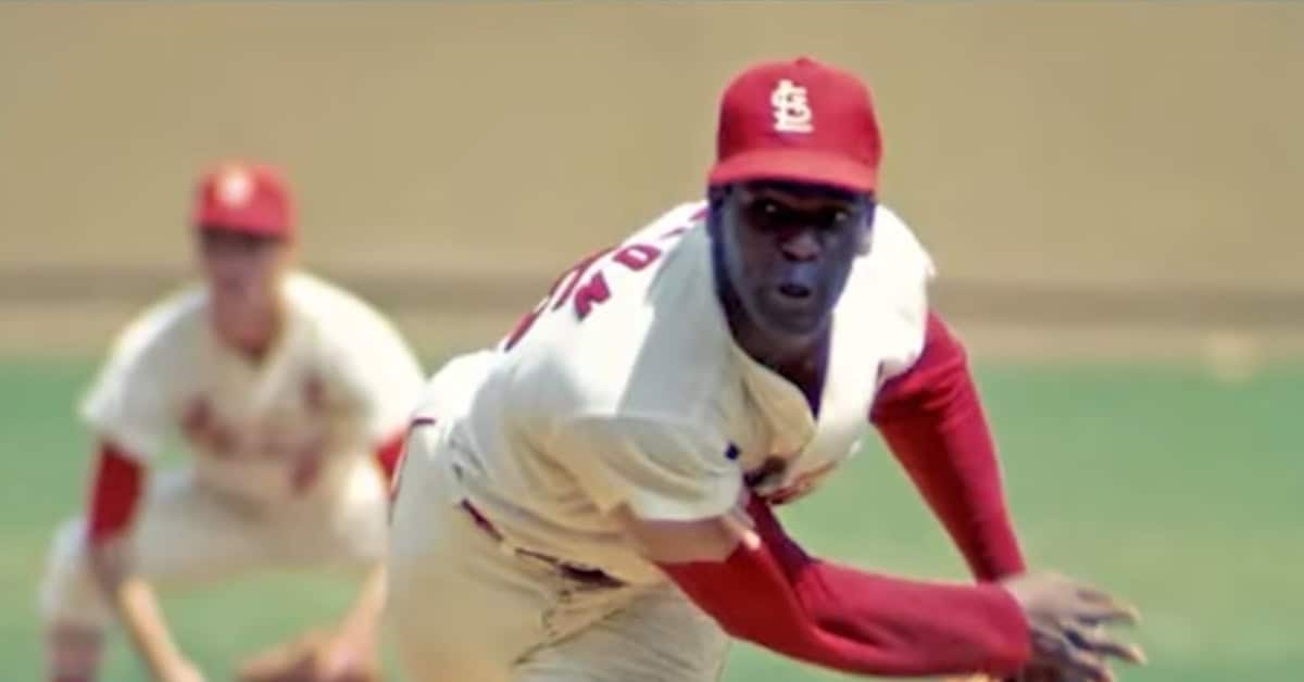 Legendary pitcher Bob Gibson hurling the ball, pivotal in changing MLB rules.