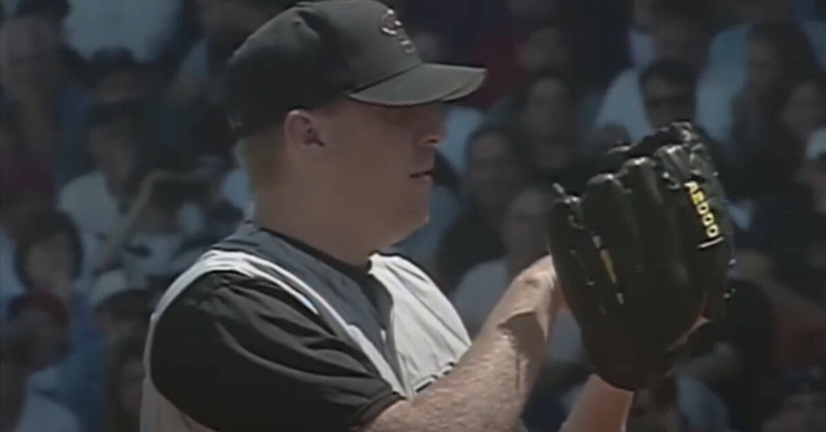 20 Pitchers Who Turned the Slider Into an Unfair Advantage 15 Curt Schilling delivering a powerful fastball, showcasing his impact on NL West baseball.