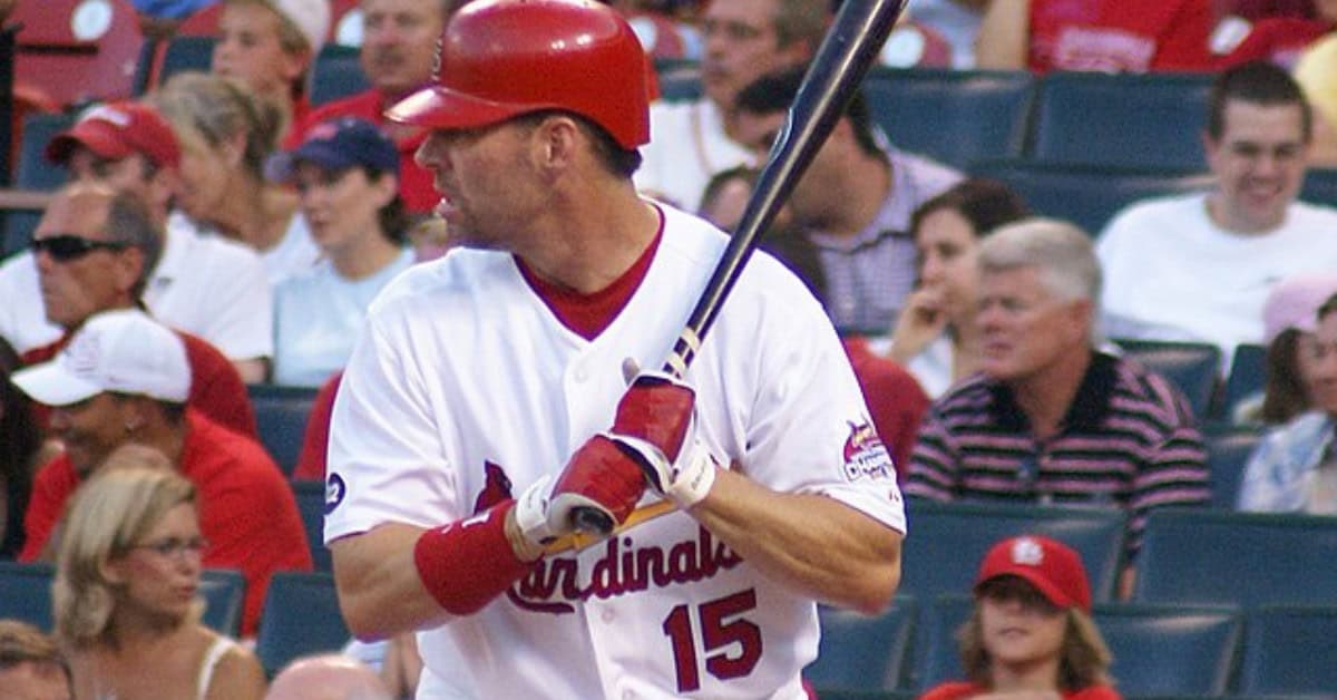 Forgotten Bombers: 10 Power Hitters the 2000s Quietly Buried 5 Jim Edmonds making a spectacular catch in center field, showcasing his talent.