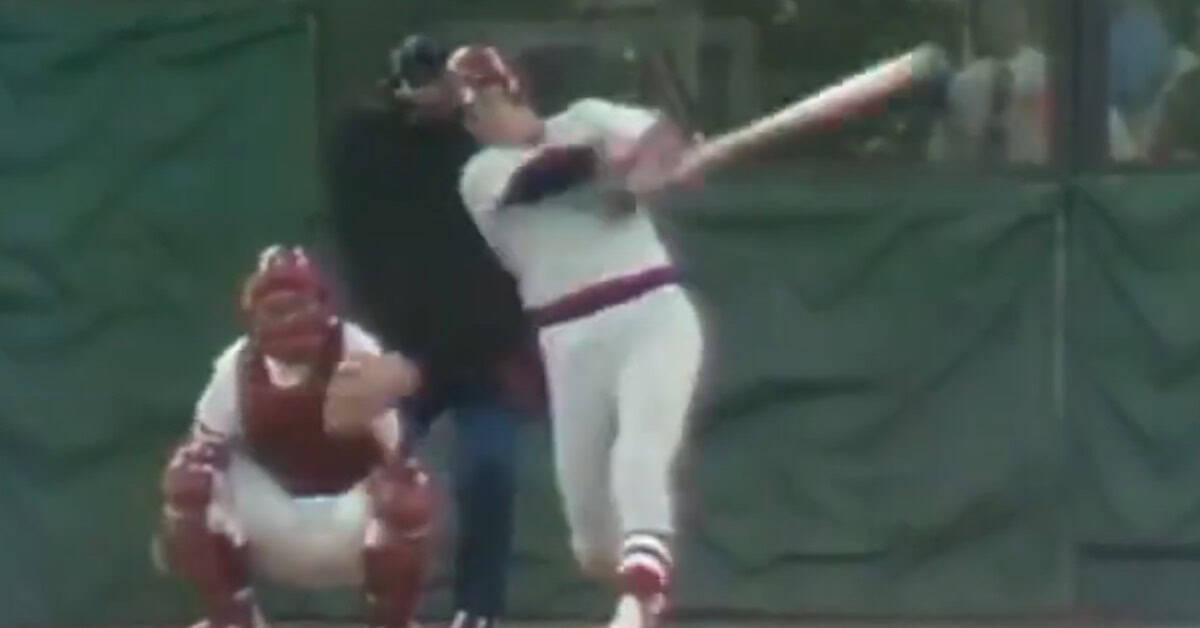 Carlton Fisk swings for a home run, showcasing his legendary hitting prowess.